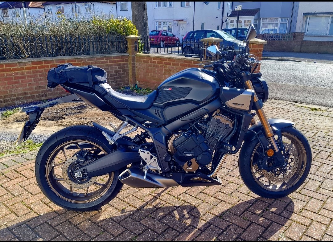 My Honda CB650R, black, parked outside in London with a tail bag fitted, side profile in afternoon sun